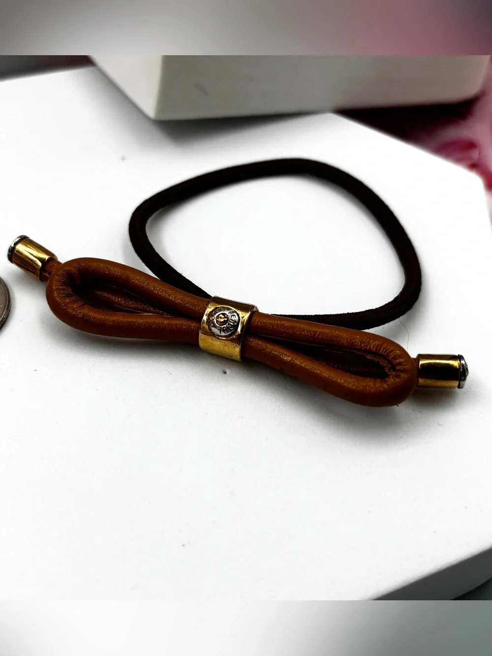 Henri Bendel Gold Tone leather bow Iconic Signed Hair Tie Pony-tail Holder